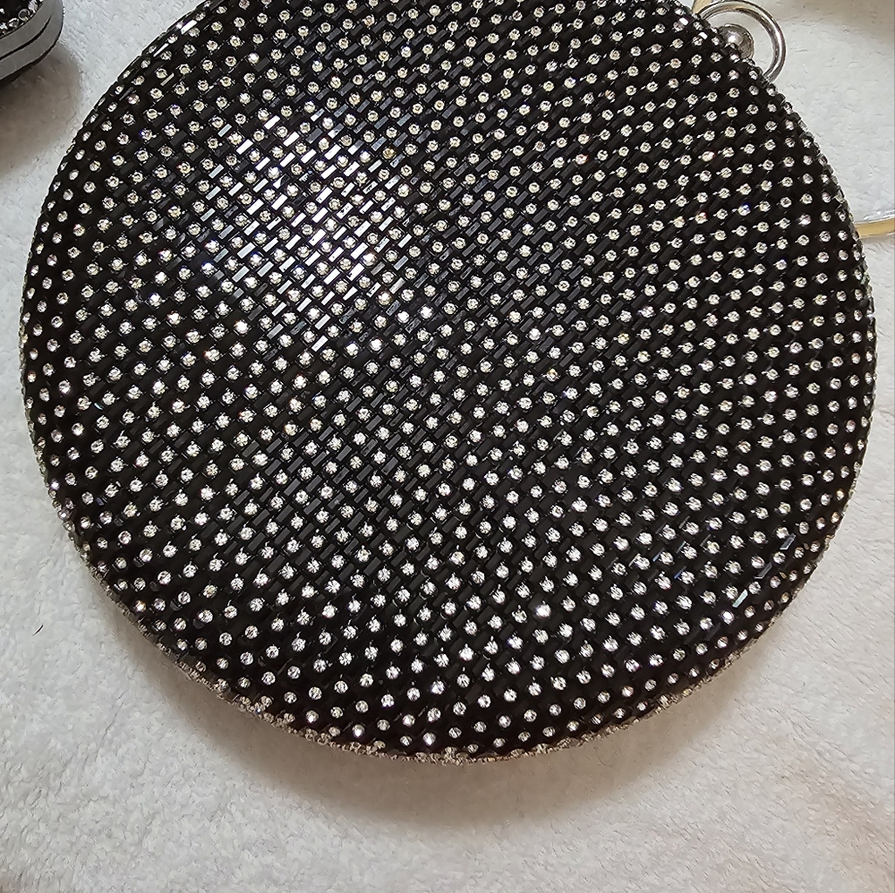 This is a spectacular black, round, blinged out rhinestone purse with chain.